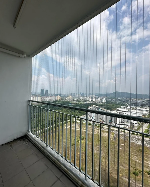 Vertical cables across a balcony with a view of the surrounding skyline.